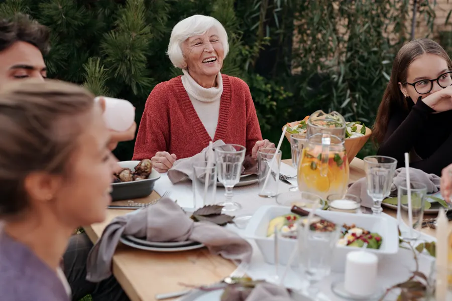 A family laughing together around a dinner table